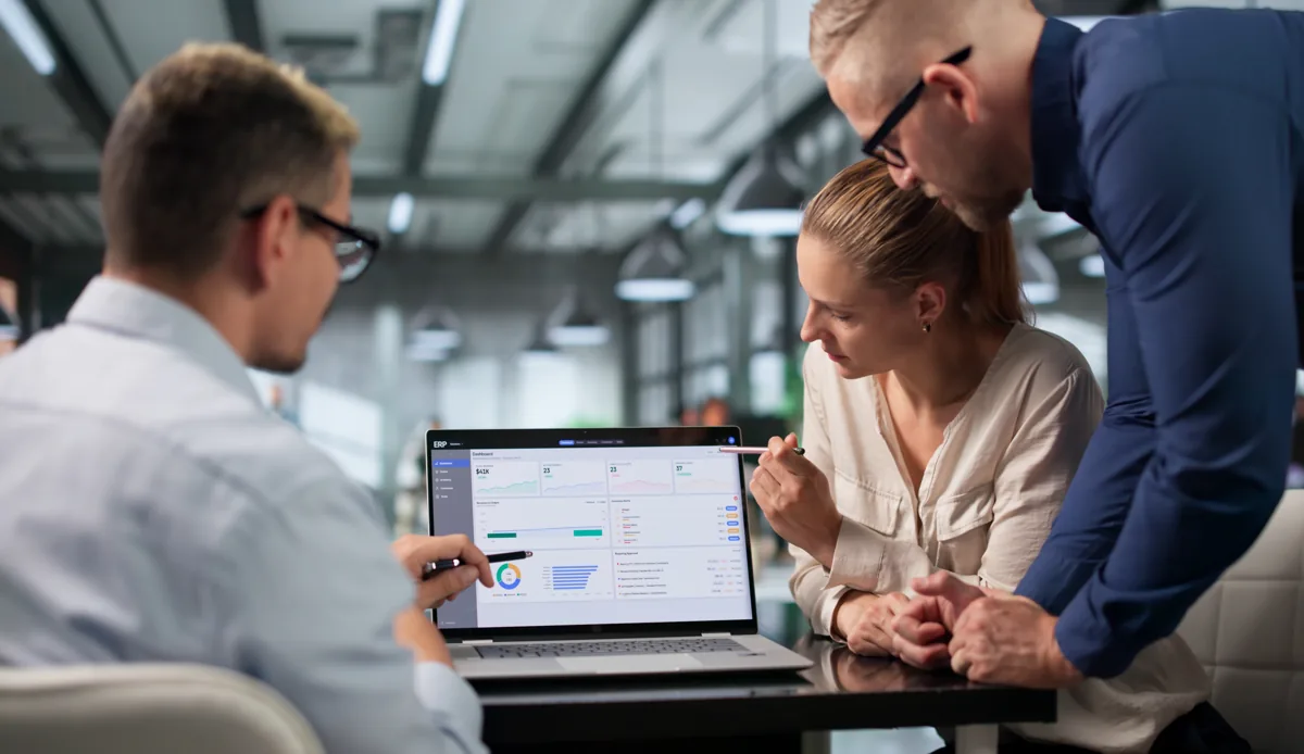 Business team reviewing a project plan together on a laptop